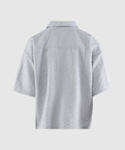 Back view of a light grey textured short sleeve men's shirt on a plain background
