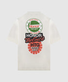 White streetwear t-shirt with bold red, black, and green graphic text and circular logos on back