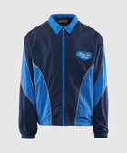 Men's blue zip-up streetwear windbreaker jacket with contrast piping and embroidered patch