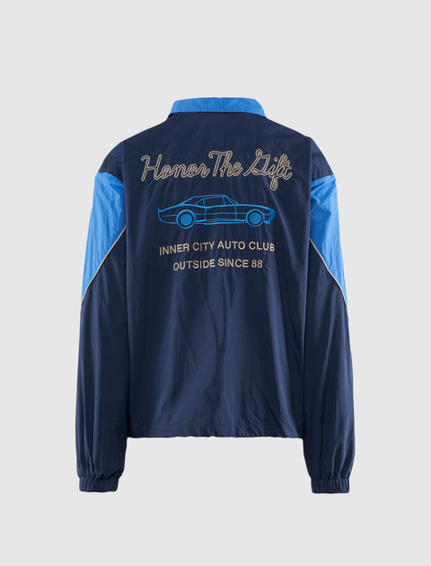 Navy and blue men's streetwear jacket with embroidered car and 'Honor The Gift' text on back