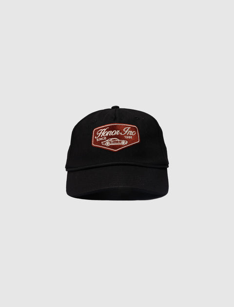 Black streetwear baseball cap with brown 'Honor Inc' patch and sports car embroidery