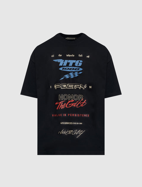 Black streetwear t-shirt with bold graphic text, racing motifs, and multicolor typography.