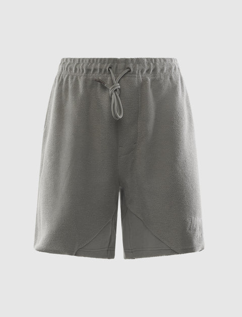 Stone grey men's streetwear shorts with drawstring waistband, front view on white background