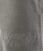 Close-up of grey textured fabric with 'Honor the Gift' embroidered text