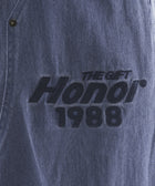 Blue denim fabric with black embroidered text reading 'The Gift Honor 1988'.