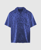 Men’s blue short sleeve button-up shirt with subtle polka dot pattern and chest pocket
