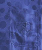 Blue polka dot shirt pocket with embroidered H logo, streetwear apparel detail