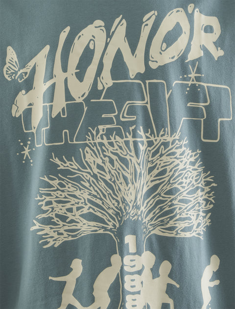 Blue graphic t-shirt featuring 'Honor The Gift' text, tree illustration, running figures, and 1988.