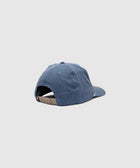 Denim blue snapback hat with adjustable beige strap, back view on light background