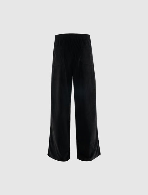 Back view of black wide-leg corduroy pants with elastic waistband and patch pockets