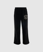 Black relaxed fit pants with elastic waistband and white graphic patch on left thigh