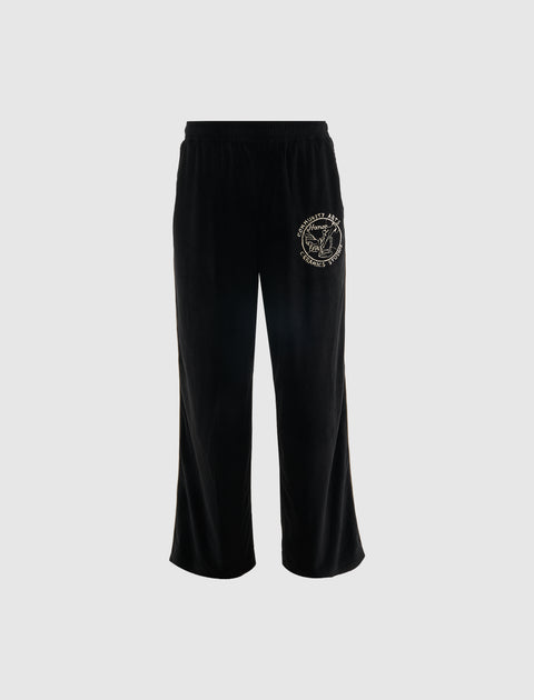 Black relaxed fit pants with elastic waistband and white graphic patch on left thigh