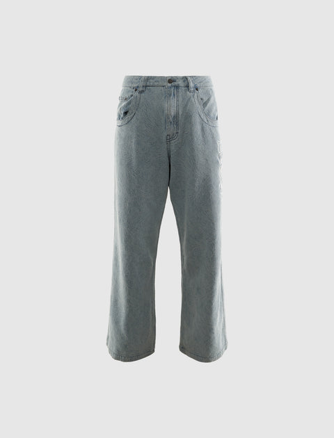 Men's light wash wide-leg jeans with subtle textured pattern, streetwear style