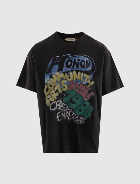 Black streetwear graphic t-shirt with colorful 'Honor Community Arts Since 1988' print.