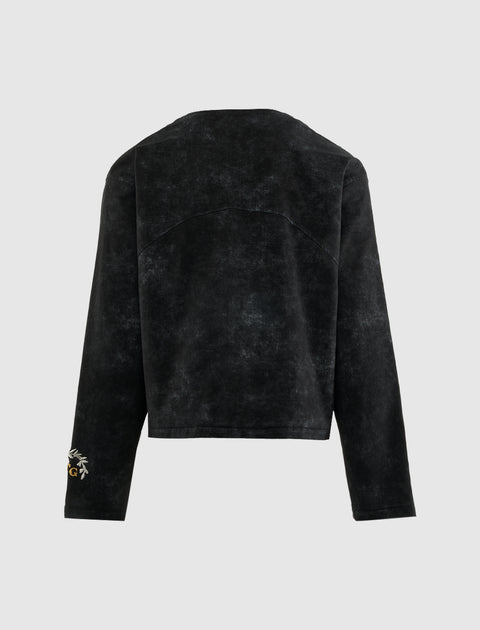 Back view of black long sleeve men's streetwear top with subtle washed texture and sleeve embroidery