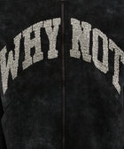 Black streetwear jacket with textured 'WHY NOT' lettering on chest, close-up view