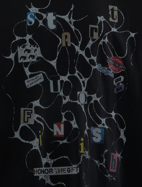 Black graphic streetwear tee with abstract web pattern, collage text, and bold letter details