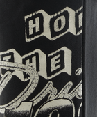 Close-up of black streetwear t-shirt with bold, vintage white graphic text print