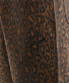 Close-up of brown leopard print men's pants with stitched cross logo detail