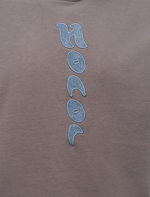 Grey streetwear top with blue textured embroidered vertical graphic detail