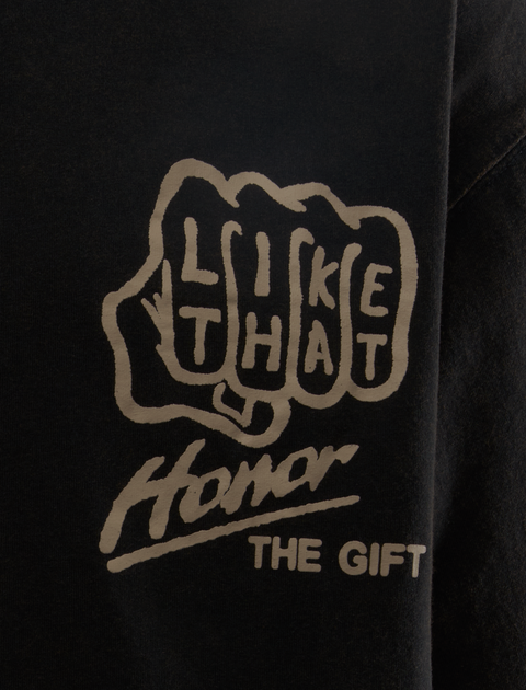 Black streetwear shirt with white graphic, knuckle design and text 'LIKE THAT Honor THE GIFT' on chest