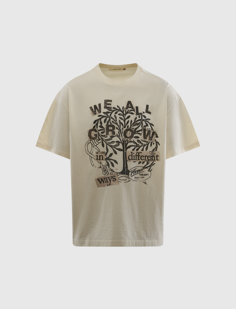 Beige graphic streetwear t-shirt with tree and 'We all grow in different ways' text design.