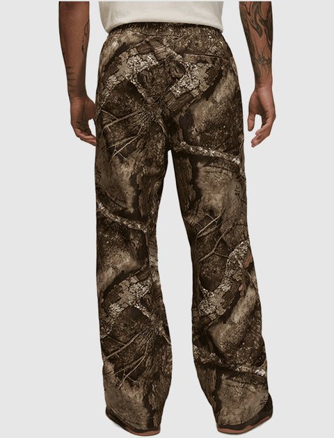 Back view of men's loose fit pants with brown camouflage pattern and elastic waistband.