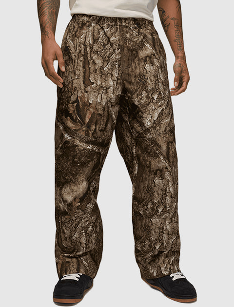 Men's relaxed fit camo pants with brown and grey tree bark pattern, streetwear style