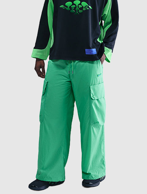 Men's bright green wide-leg cargo pants with large pockets, styled for streetwear fashion