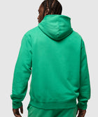 Man in green distressed hoodie and sweatpants, back view, streetwear apparel