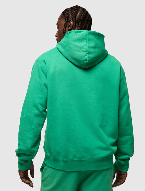 Man in green distressed hoodie and sweatpants, back view, streetwear apparel