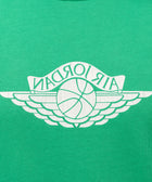 Green streetwear T-shirt with white basketball wings graphic and bold lettering detail