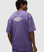 Man wearing purple Nike Air t-shirt with back logo and distressed details