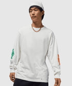 Man in white long sleeve streetwear shirt with colored sleeve graphics and white beanie