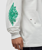 White long sleeve shirt with green Air Jordan wing logo on sleeve and small distressed holes.