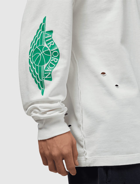 White long sleeve shirt with green Air Jordan wing logo on sleeve and small distressed holes.