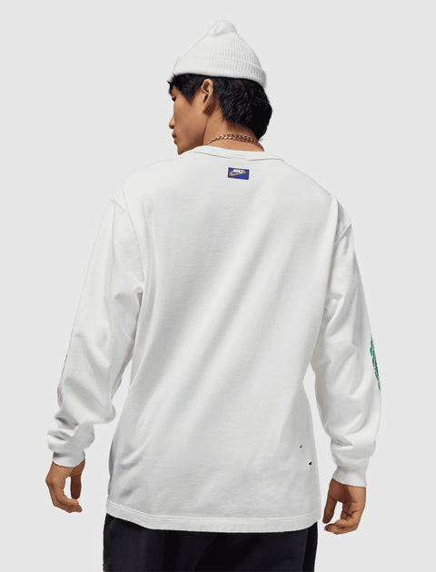 Man in white long sleeve Nike shirt and knit beanie, streetwear apparel, back view