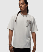 Man wearing white streetwear t-shirt with black basketball hoop graphic on chest