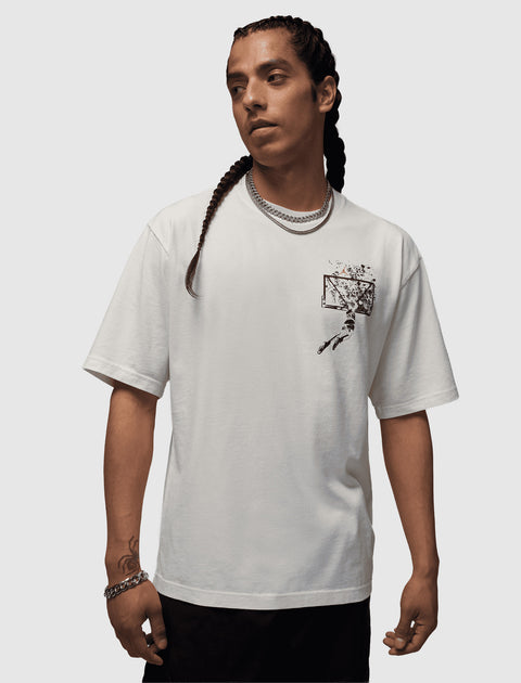 Man wearing white streetwear t-shirt with black basketball hoop graphic on chest