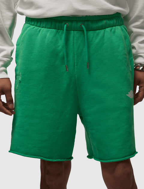 Green fleece men's streetwear shorts with drawstring waist and raw hem