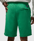 Back view of green men's Nike shorts with rear pocket and elastic waistband