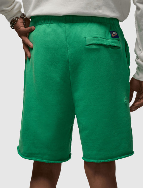 Back view of green men's Nike shorts with rear pocket and elastic waistband
