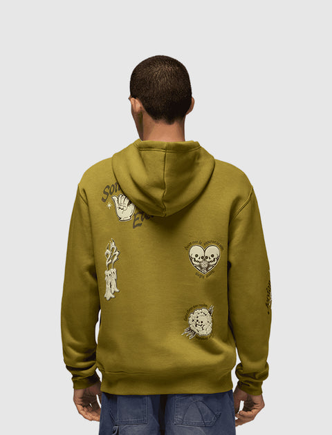 Man wearing olive green hoodie with graphic prints on back, streetwear fashion style