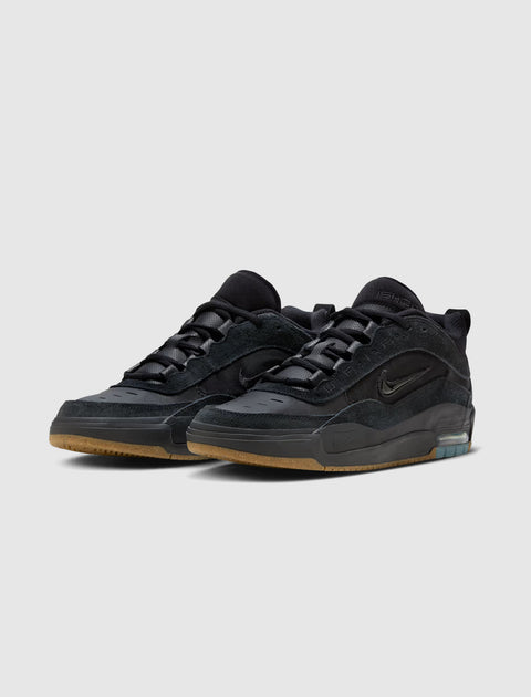 Black low-top sneakers with suede and leather details, gum sole, and visible air cushioning
