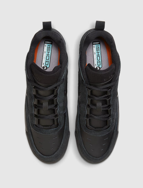 Top view of black suede and leather skate sneakers with padded collars and Ishod branding on insoles