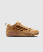 Tan low top sneaker with suede upper, visible air sole, and side swoosh logo on white background