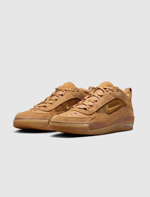 Tan suede low-top sneakers with gum soles and side swoosh logo on a light background