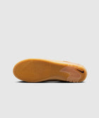 Gum sole skate shoe outsole with herringbone tread pattern and Nike Swoosh logo