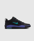 Black low-top sneaker with teal swoosh and purple midsole on light grey background