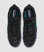 Top view of black sneakers with teal accents and purple trim against a light background.